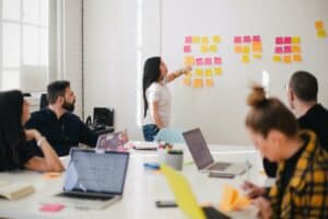 Woman Pointing At Notes on Whiteboard