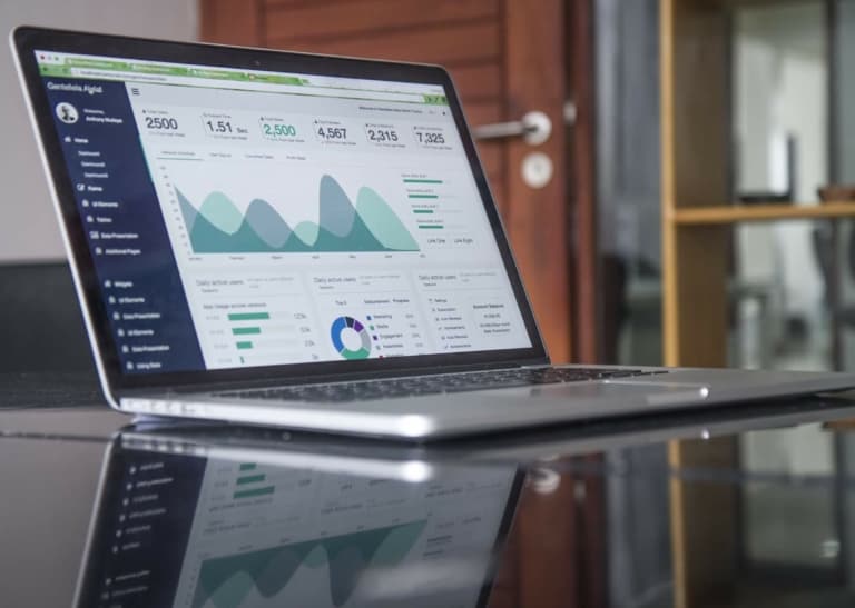 laptop on table showing website analytics