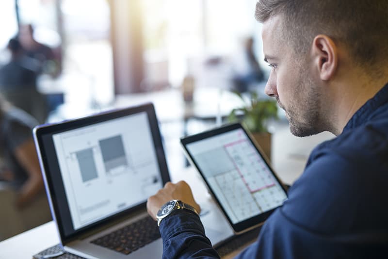 Business man looking and analyzing email service providers on his laptop comput