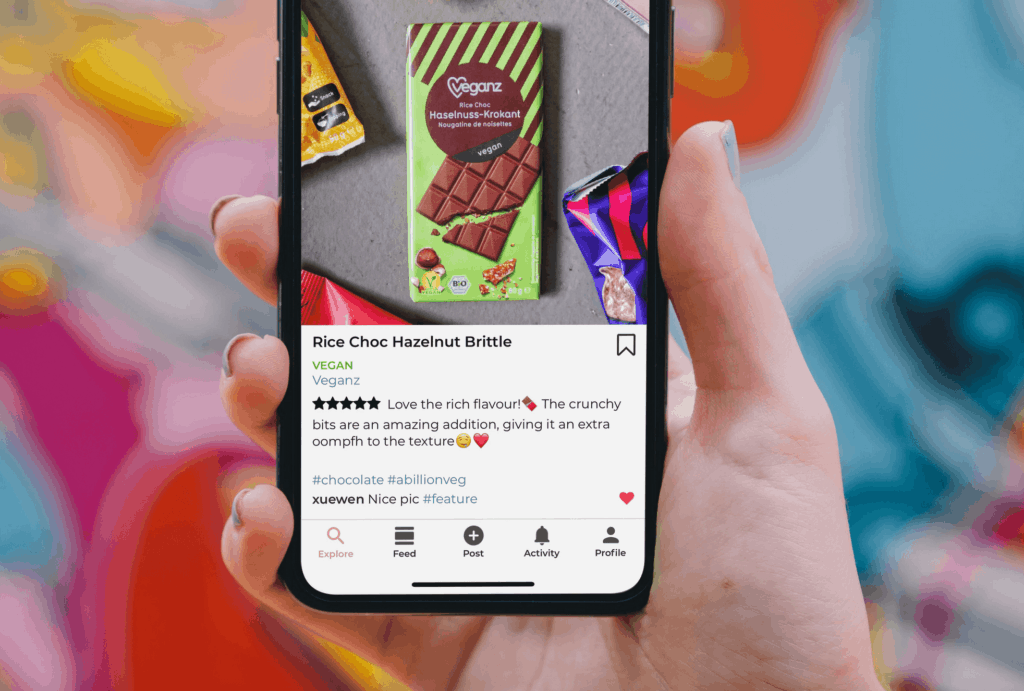 person holding cellphone showing review and comments on an ecommerce post promoting vegan chocolate