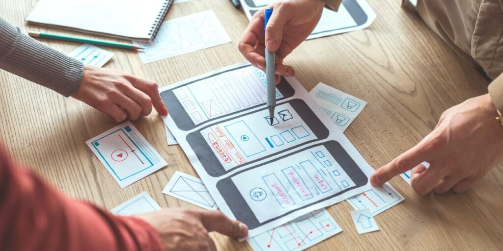 People pointing at a mock-up of a mobile website